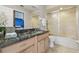 Bathroom features a granite countertop vanity, mirror and shower with glass door at 1902 Sweet Bay Ct, Plant City, FL 33566