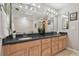 Elegant bathroom vanity featuring dual sinks, granite countertops, and ample lighting at 1902 Sweet Bay Ct, Plant City, FL 33566