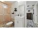 Bathroom featuring shower, white vanity and a glimpse into the adjacent bedroom at 1902 Sweet Bay Ct, Plant City, FL 33566