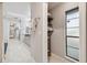 Hallway leading to a bright bathroom with double vanity and walk-in closet at 1902 Sweet Bay Ct, Plant City, FL 33566