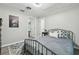 Bedroom featuring a metal frame bed and artwork on the wall at 1902 Sweet Bay Ct, Plant City, FL 33566