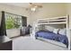 Bright bedroom with a bunk bed, a large window, and soft carpet flooring at 1902 Sweet Bay Ct, Plant City, FL 33566