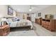 Spacious bedroom featuring light wood flooring, a plush bed, and ample storage space at 1902 Sweet Bay Ct, Plant City, FL 33566