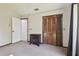 Neutral bedroom with a carpeted floor, wooden closet doors, and a small bedside table at 1902 Sweet Bay Ct, Plant City, FL 33566