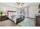 Cozy bedroom features plush carpet, a ceiling fan, and a large window that provides ample natural light at 1902 Sweet Bay Ct, Plant City, FL 33566