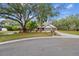 Landscaped front yard leads to a traditional brick home with a large front lawn and attached garage at 1902 Sweet Bay Ct, Plant City, FL 33566