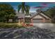 Charming brick home featuring a well-maintained yard, mature landscaping, and a spacious driveway at 1902 Sweet Bay Ct, Plant City, FL 33566