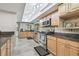 Kitchen offers stainless appliances, granite counters, wood cabinets and light tile flooring at 1902 Sweet Bay Ct, Plant City, FL 33566