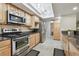 This kitchen features stainless steel appliances, light wood cabinets, and dark granite countertops at 1902 Sweet Bay Ct, Plant City, FL 33566