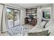 Comfortable office space featuring a computer desk, a bookshelf, and a sliding glass door to the outdoors at 1902 Sweet Bay Ct, Plant City, FL 33566