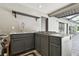 Outdoor kitchen with sink, cooktop, and cabinets within the screened lanai at 1902 Sweet Bay Ct, Plant City, FL 33566