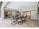 Outdoor patio with table, chairs, ceiling fan, and multiple glass doors into the home at 1902 Sweet Bay Ct, Plant City, FL 33566