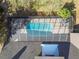 Overhead shot of the screened pool with clear blue water, adjacent to a gray shingled roof at 1902 Sweet Bay Ct, Plant City, FL 33566