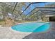 Inviting pool with a rock waterfall and ladder surrounded by brick pavers, inside screened enclosure at 1902 Sweet Bay Ct, Plant City, FL 33566