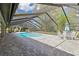 Large screened pool with waterfall feature, ample seating area, and views of the spacious backyard at 1902 Sweet Bay Ct, Plant City, FL 33566
