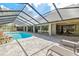 Inviting pool, landscaped rock feature, and a screened enclosure, offering a private outdoor oasis at 1902 Sweet Bay Ct, Plant City, FL 33566