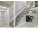 Elegant staircase with white banister, gray carpet, and decorative black piano on the first floor at 1902 Sweet Bay Ct, Plant City, FL 33566
