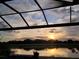 Backyard view featuring water and a sunset sky at 20237 Bandera Pl, Venice, FL 34293