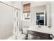 Bathroom features white tiled shower/tub, a vanity with mirror and dark wood accents at 20237 Bandera Pl, Venice, FL 34293