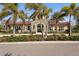 Exterior shot of the building, surrounded by lush palm trees at 20237 Bandera Pl, Venice, FL 34293