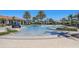 Large community pool with multiple seating areas and lush landscaping at 20237 Bandera Pl, Venice, FL 34293