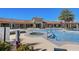 Community pool with a hot tub and lounge chairs, surrounded by tropical landscaping at 20237 Bandera Pl, Venice, FL 34293