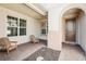 Inviting front porch with brick pavers and two wood Adirondack chairs, perfect for relaxing at 20237 Bandera Pl, Venice, FL 34293