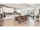 Open kitchen with white cabinets, an island with seating, and stainless steel appliances at 20237 Bandera Pl, Venice, FL 34293