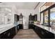 Modern kitchen features dark cabinets, granite countertops, and stainless steel appliances at 20237 Bandera Pl, Venice, FL 34293