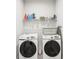 Functional laundry room with a washer, dryer, shelving and cleaning supplies at 20237 Bandera Pl, Venice, FL 34293