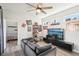 Stylish living room with a comfortable sofa, large TV, and sports-themed decor at 20237 Bandera Pl, Venice, FL 34293