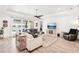 Open living room with tile flooring, recessed lighting, and sliding glass doors to the lanai at 20237 Bandera Pl, Venice, FL 34293