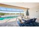 Outdoor patio and pool area with a beautiful lake view and dining set at 20237 Bandera Pl, Venice, FL 34293