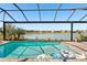 Beautiful pool overlooking a scenic lake view with palm trees at 20237 Bandera Pl, Venice, FL 34293