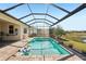 Beautiful screened-in pool with a picturesque lake view and relaxing ambiance at 20237 Bandera Pl, Venice, FL 34293