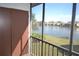 Screened-in balcony features a storage closet, offering extra space and a relaxing lake view at 256 Cypress Ln # 120, Oldsmar, FL 34677