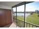 Enjoy peaceful lake views from this screened balcony with extra storage; a relaxing outdoor space at 256 Cypress Ln # 120, Oldsmar, FL 34677
