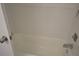 Clean white bathtub with a shower head and controls in a bright and tidy bathroom at 256 Cypress Ln # 120, Oldsmar, FL 34677