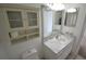 Bathroom with a new vanity, toilet, medicine cabinet and decorative mirror at 256 Cypress Ln # 120, Oldsmar, FL 34677