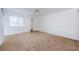 Bright bedroom featuring a ceiling fan, closet, and window letting in natural light at 256 Cypress Ln # 120, Oldsmar, FL 34677