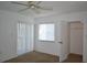 Bright bedroom featuring a ceiling fan, closet, and a window letting in natural light at 256 Cypress Ln # 120, Oldsmar, FL 34677