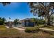 Inviting community pool area with mature trees and manicured landscaping on a bright, sunny day at 256 Cypress Ln # 120, Oldsmar, FL 34677