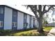 Apartment building exterior with stairs and lush green landscaping at 256 Cypress Ln # 120, Oldsmar, FL 34677