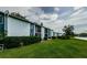 Exterior of a two-story building featuring a patio and green lawn at 256 Cypress Ln # 120, Oldsmar, FL 34677