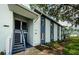 Exterior of a two-story building featuring white siding and blue trim with staircase at 256 Cypress Ln # 120, Oldsmar, FL 34677
