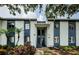 Exterior of a two-story building featuring white siding and blue trim with staircase at 256 Cypress Ln # 120, Oldsmar, FL 34677