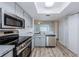 Open concept kitchen features stainless appliances, gray cabinets, and a door at 256 Cypress Ln # 120, Oldsmar, FL 34677