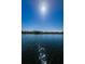 Beautiful lake view showcasing waterfront homes and clear blue skies on a sunny day at 256 Cypress Ln # 120, Oldsmar, FL 34677