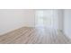 Bright and airy living area featuring sliding glass doors and modern wood grain flooring at 256 Cypress Ln # 120, Oldsmar, FL 34677