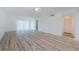 Spacious and bright living area featuring modern wood grain flooring and abundant natural light at 256 Cypress Ln # 120, Oldsmar, FL 34677